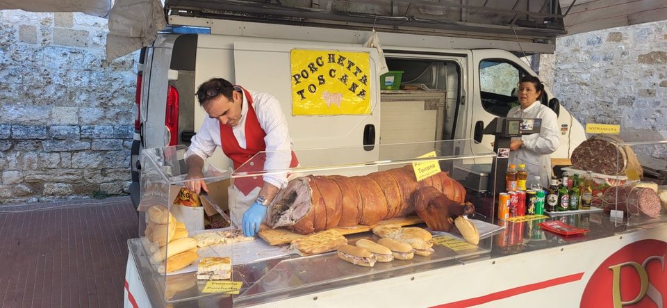 A whole roast pig at a San Gimignano food stand